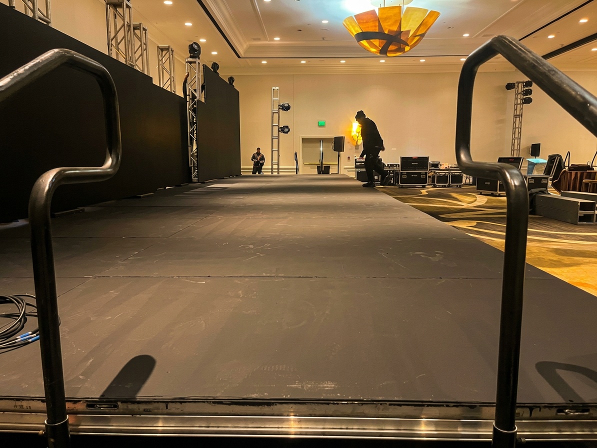 Corporate runway setup with branded backdrop and professional lighting at convention center