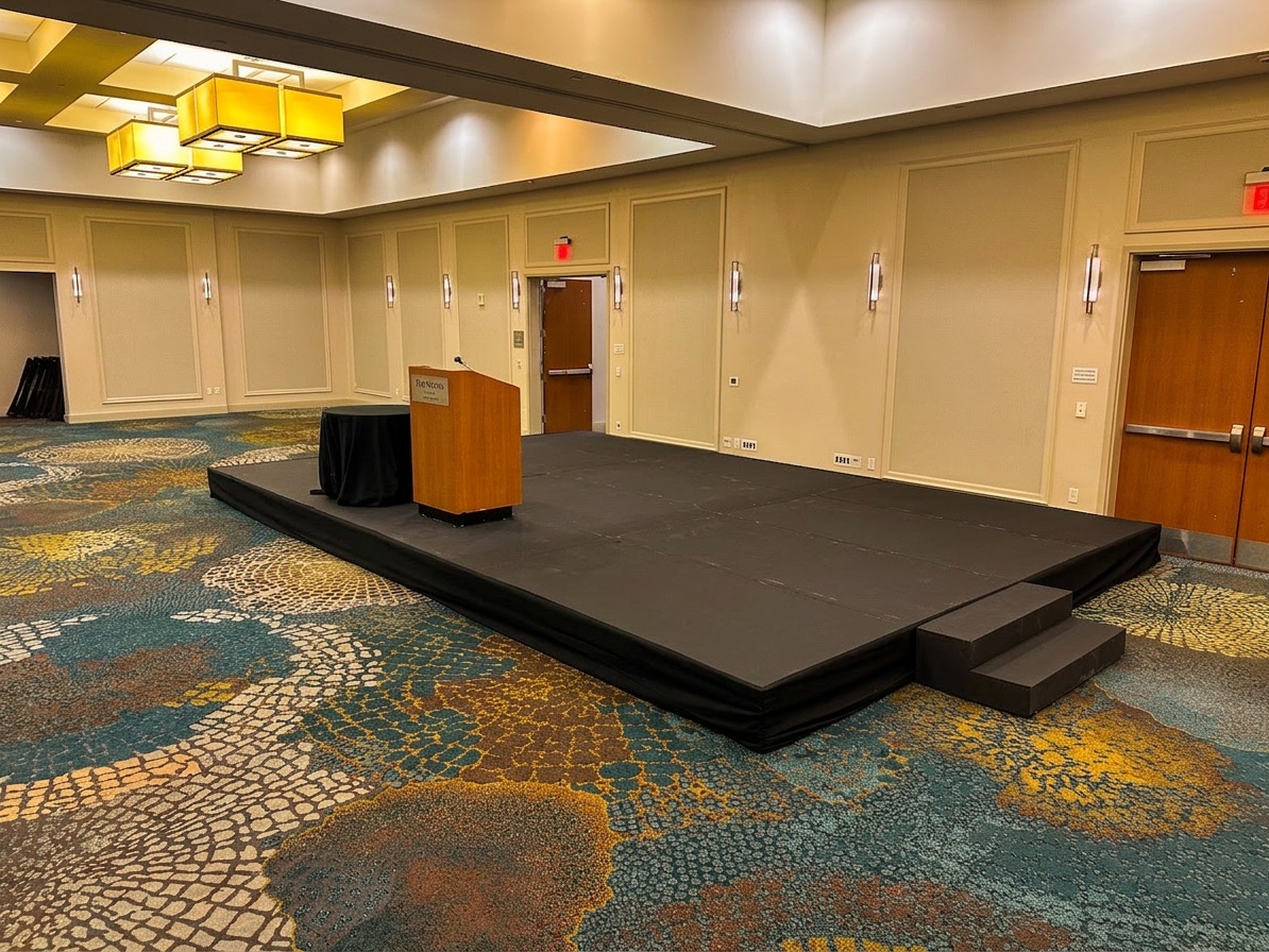 small speaking stage set up outdoors at a community event in Central Florida with skirting and a podium