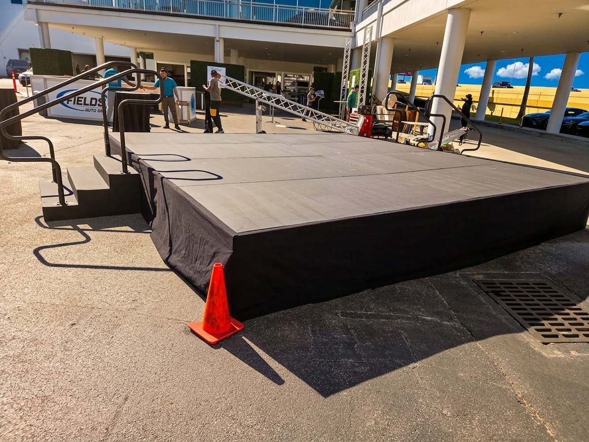 Close-up of stage deck locking mechanism and guard rail attachment points showing secure connection