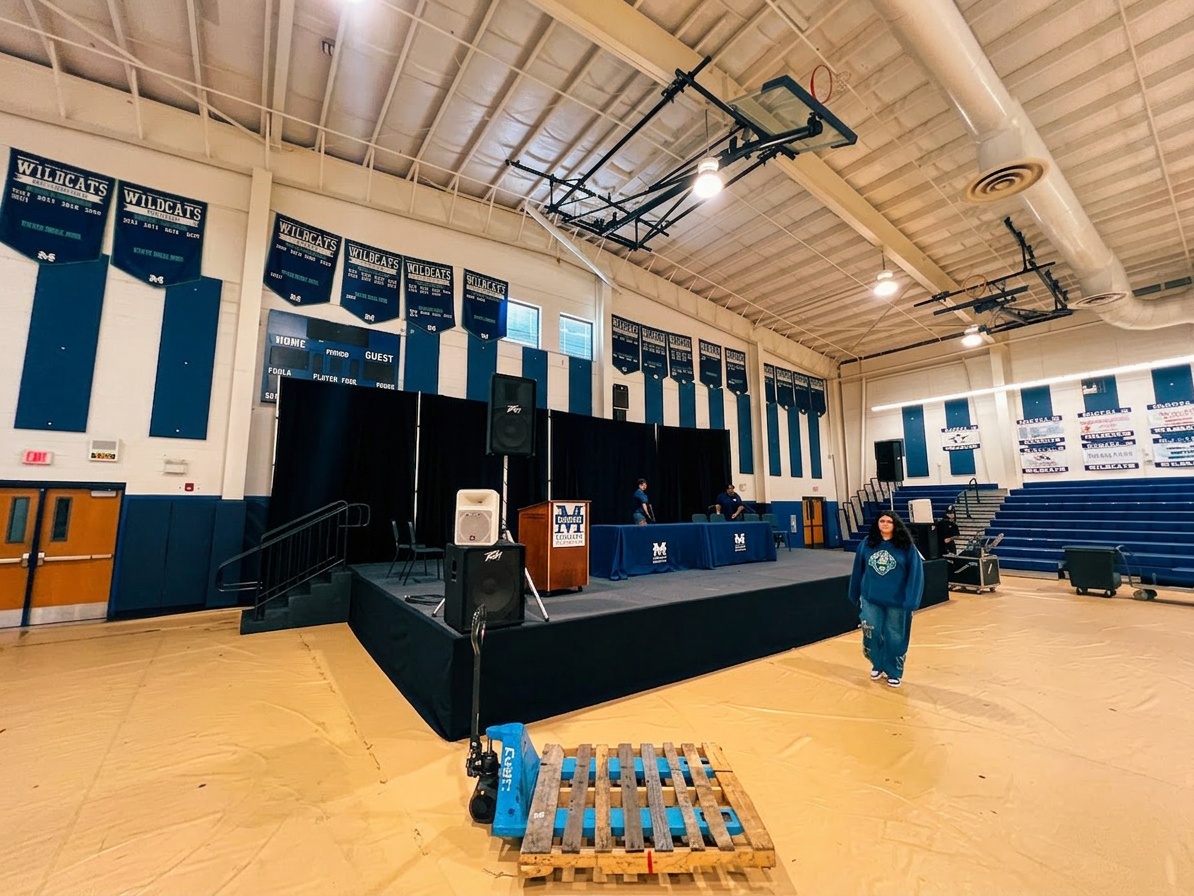 full stage setup with pipe and drape backdrop and stage skirting at an indoor Orlando event venue