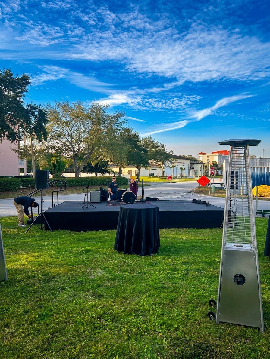 16ft deep stage setup with a full band configuration showing drum kit, floor monitors, and backline gear in a smaller Central Florida event venue