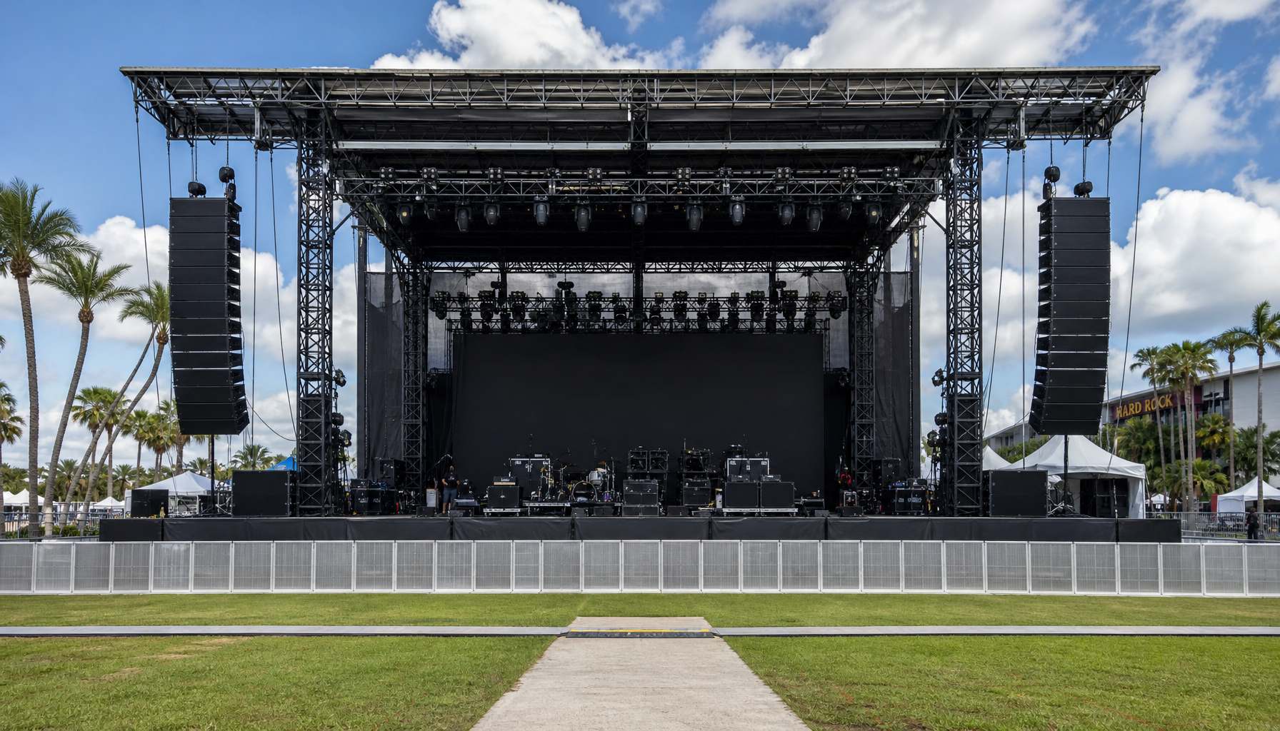 wide concert stage setup outdoors with speaker arrays on both sides of the stage, Central Florida event venue