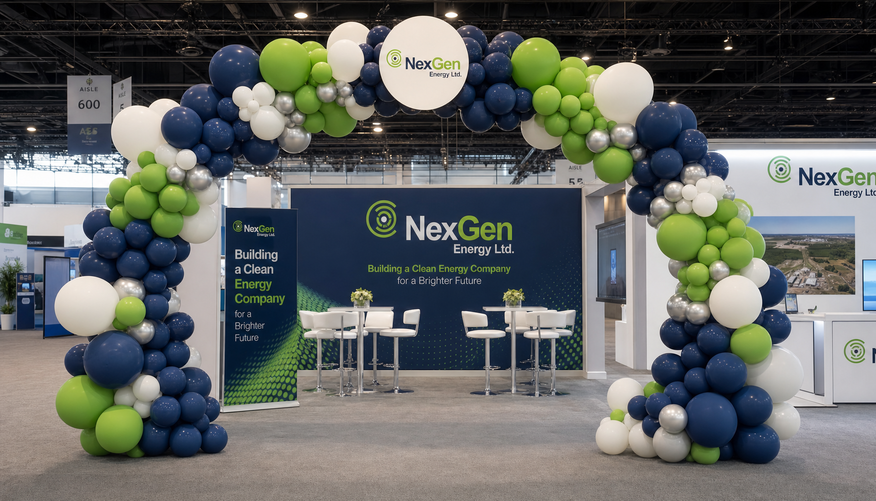 corporate branded balloon arch in company colors at a trade show entrance with a banner backdrop